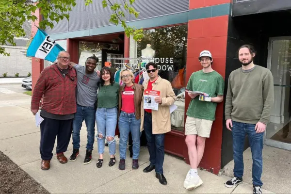 TNG-CWA Local 34043 members stand in front of window