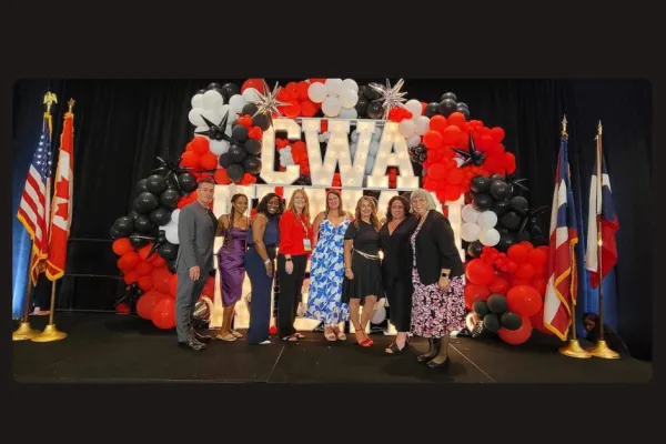 District 2-13 members in front of CWA red white and black sign