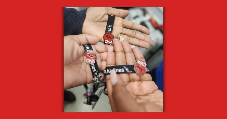three hands with CWA strong pins on American Airline lanyards