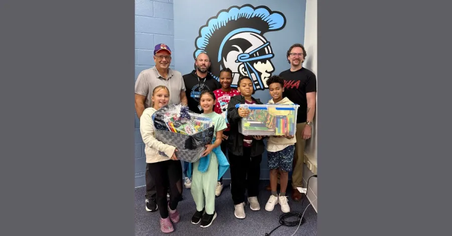 CWA Local 14815 officers with middle schoolers and school supplies