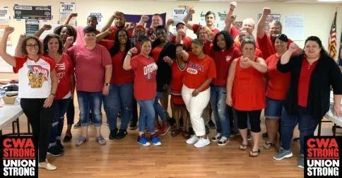 Call Center Workers in Virginia with fists in the air.