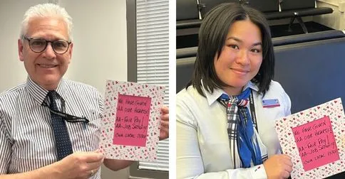 Two American Airlines Agents hold mobilization Valentine signs