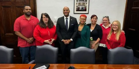 CWA members in red with Maryland Governor Moore